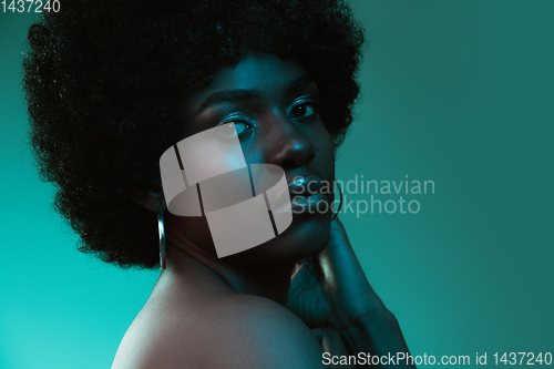 Image of Portrait of female high fashion model in neon light