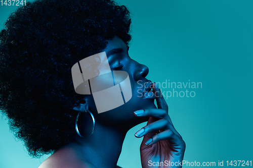 Image of Portrait of female high fashion model in neon light