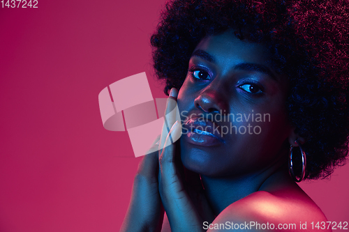 Image of Portrait of female high fashion model in neon light