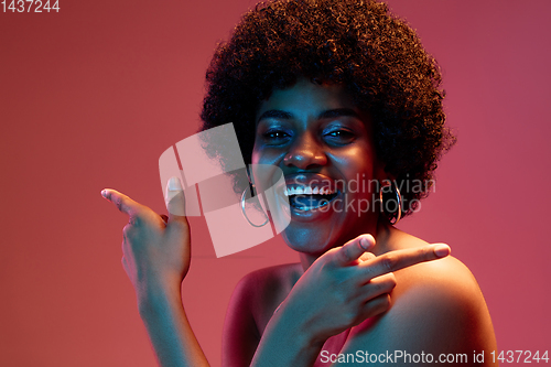 Image of Portrait of female high fashion model in neon light