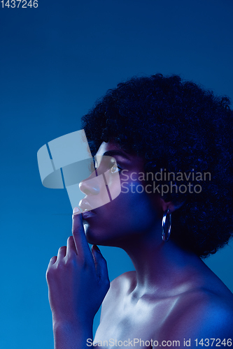 Image of Portrait of female high fashion model in neon light