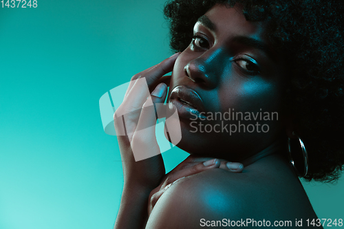 Image of Portrait of female high fashion model in neon light