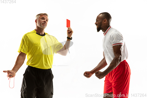 Image of Football referee showing a red card to a displeased player isolated on white background