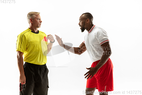 Image of Football referee showing a red card to a displeased player isolated on white background