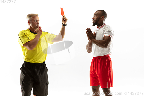 Image of Football referee showing a red card to a displeased player isolated on white background