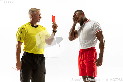 Image of Football referee showing a red card to a displeased player isolated on white background