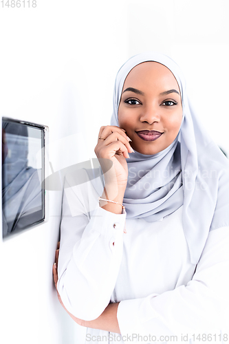 Image of african woman using smart home screen