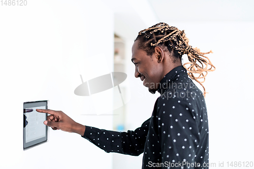 Image of African man using smart home screen
