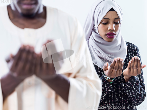 Image of african muslim couple praying