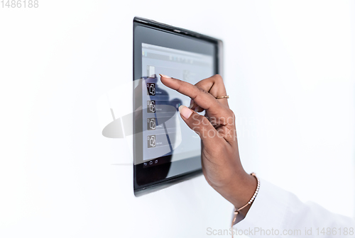 Image of african woman using smart home screen