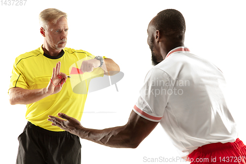 Image of Football referee showing a red card to a displeased player isolated on white background