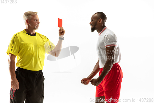 Image of Football referee showing a red card to a displeased player isolated on white background