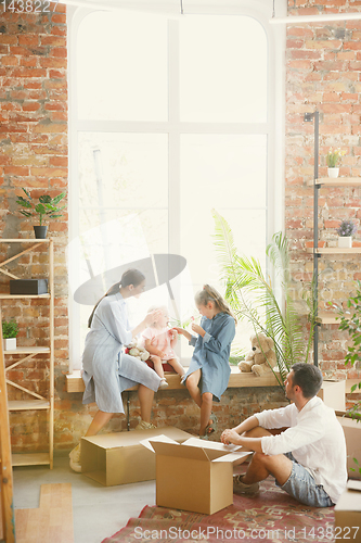 Image of Adult family moved to a new house or apartment