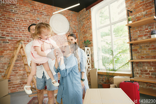 Image of Adult family moved to a new house or apartment