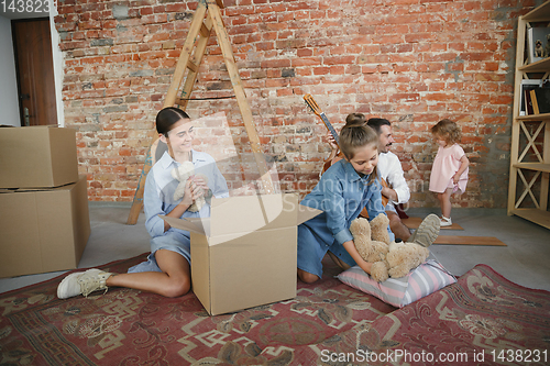 Image of Adult family moved to a new house or apartment