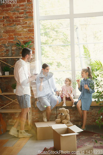 Image of Adult family moved to a new house or apartment