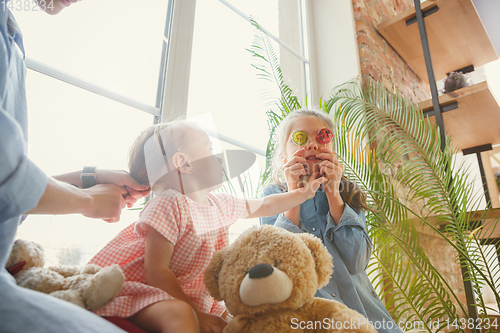 Image of Young mother and her daughters moved to a new house or apartment