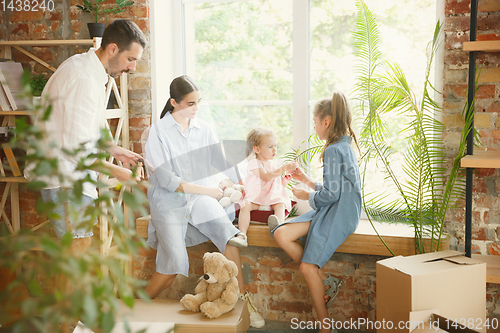 Image of Adult family moved to a new house or apartment