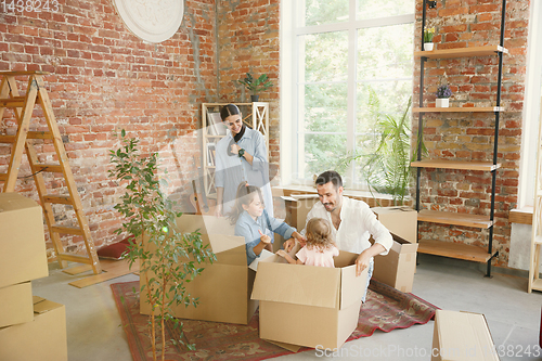 Image of Adult family moved to a new house or apartment