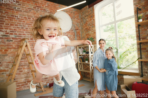 Image of Adult family moved to a new house or apartment