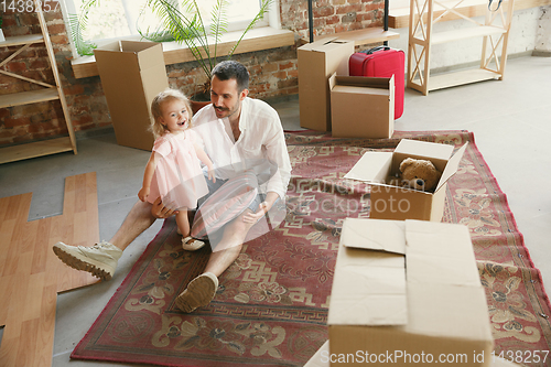 Image of Young father and his daughter moved to a new house or apartment