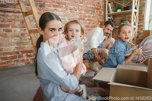 Image of Adult family moved to a new house or apartment