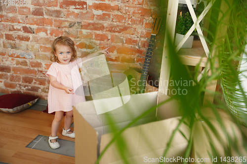 Image of Little girl moved to a new house or apartment