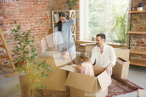 Image of Adult family moved to a new house or apartment