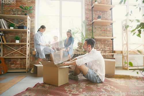 Image of Adult family moved to a new house or apartment