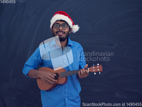 Image of Santa playing Latin America traditional small guitar