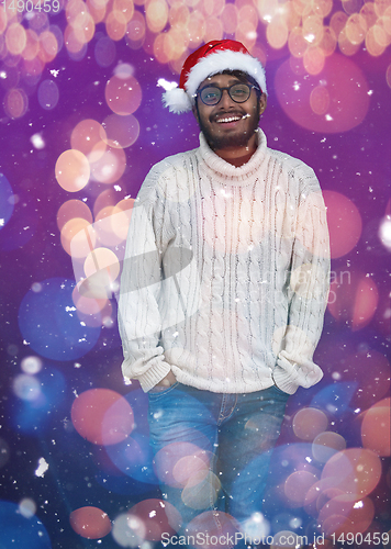 Image of Indian man wearing traditional Santa  hat  and white sweater