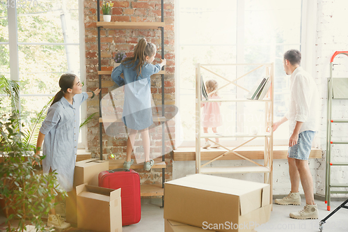 Image of Adult family moved to a new house or apartment