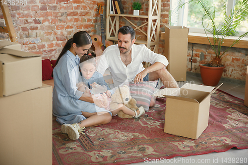 Image of Adult family moved to a new house or apartment