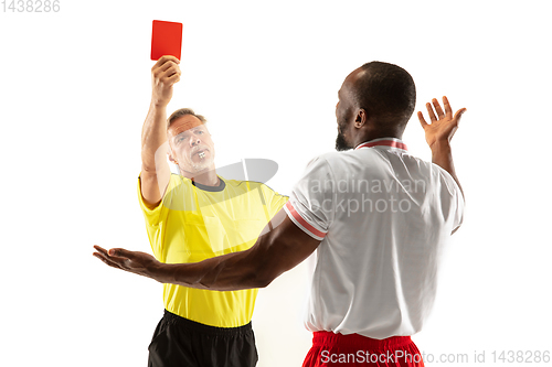 Image of Football referee showing a red card to a displeased player isolated on white background