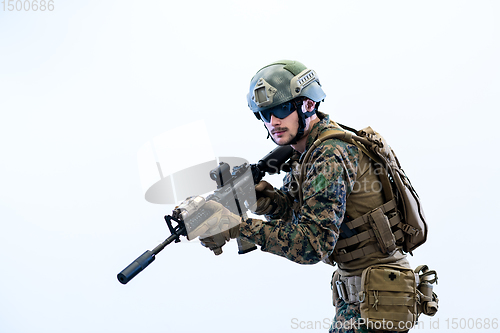 Image of soldier in action aiming laseer sight optics