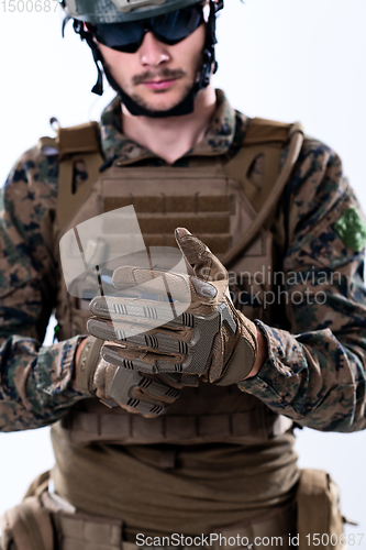 Image of closeup of soldier hands putting protective battle gloves