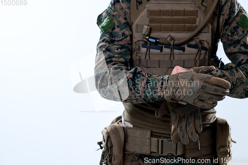 Image of closeup of soldier hands putting protective battle gloves