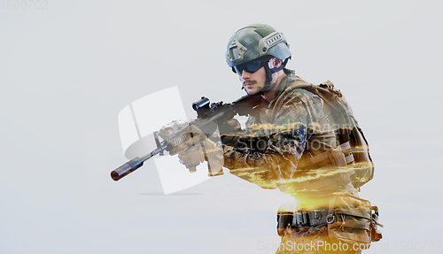 Image of soldier in action aiming laseer sight optics