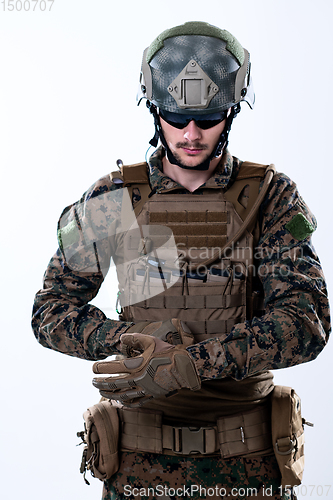 Image of closeup of soldier hands putting protective battle gloves