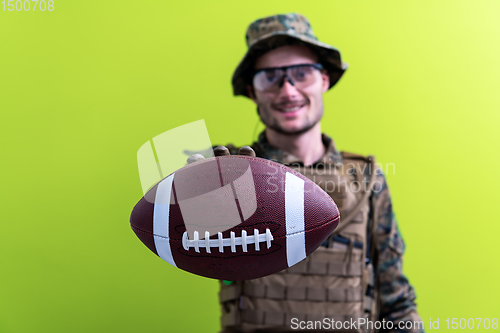 Image of solder holding american football ball