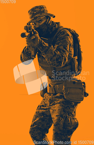 Image of soldier in action aiming laseer sight optics