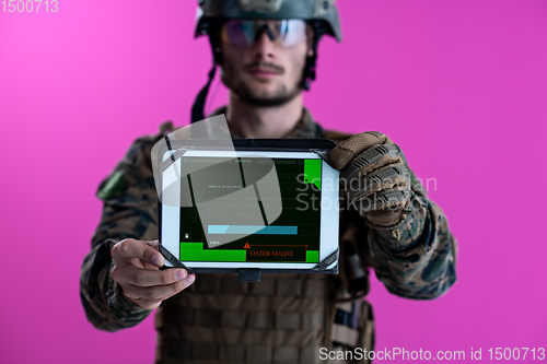 Image of soldier showing a tablet with a blank green screen