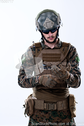 Image of closeup of soldier hands putting protective battle gloves