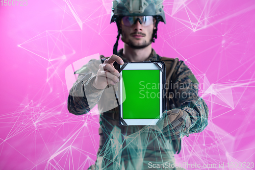 Image of soldier showing a tablet with a blank green screen