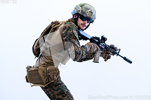 Image of soldier in action aiming laseer sight optics