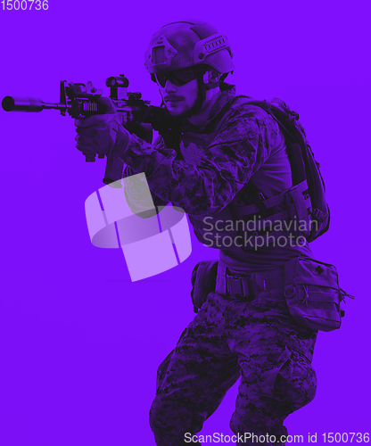 Image of soldier in action aiming laseer sight optics