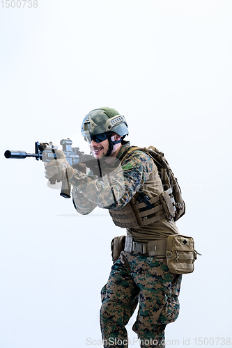 Image of soldier in action aiming laseer sight optics