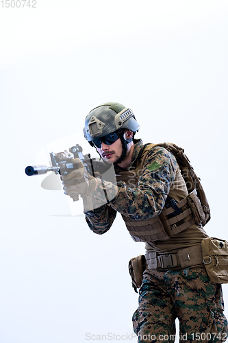 Image of soldier in action aiming laseer sight optics