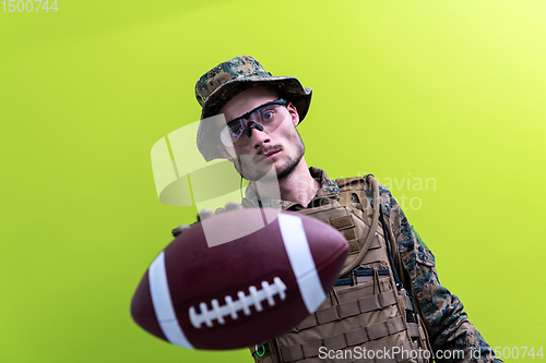 Image of solder holding american football ball