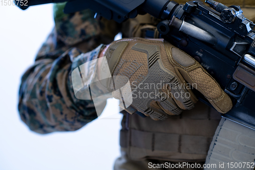 Image of soldier preparing gear for action